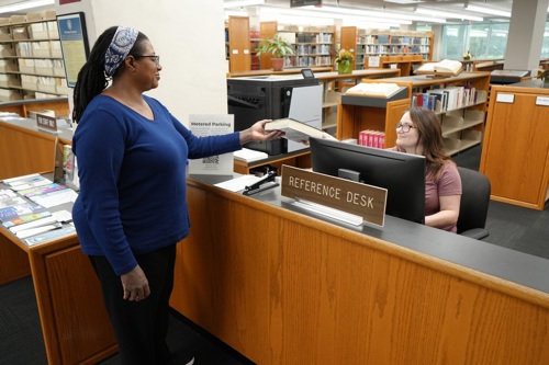 Reference staff working at the reference desk